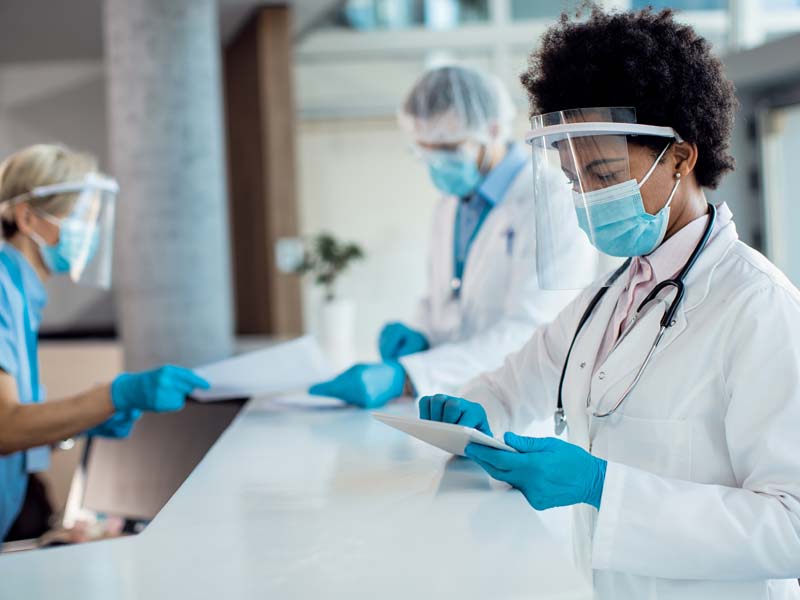 medical professional submitting patient information on tablet